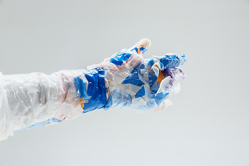 Image showing Big plastic hand made of garbage isolated on white studio background