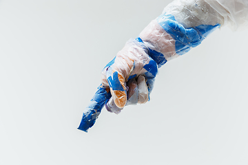 Image showing Big plastic hand made of garbage isolated on white studio background