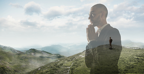 Image showing Silhouette of businessman with landscapes on background, double exposure.