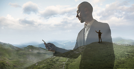 Image showing Silhouette of businessman with landscapes on background, double exposure.