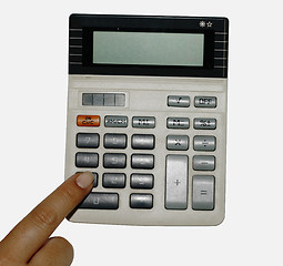 Image showing Isolated female finger an old calculator