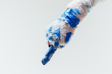 Image showing Big plastic hand made of garbage isolated on white studio background