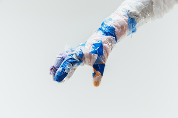 Image showing Big plastic hand made of garbage isolated on white studio background