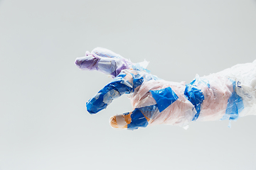 Image showing Big plastic hand made of garbage isolated on white studio background