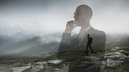 Image showing Silhouette of businessman with landscapes on background, double exposure.