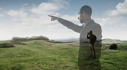 Image showing Silhouette of businessman with landscapes on background, double exposure.