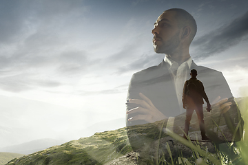 Image showing Silhouette of businessman with landscapes on background, double exposure.