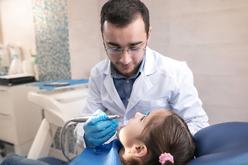 Image showing Young caucasian girl visiting dentist\'s office