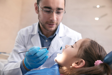 Image showing Young caucasian girl visiting dentist\'s office