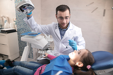 Image showing Young caucasian girl visiting dentist\'s office