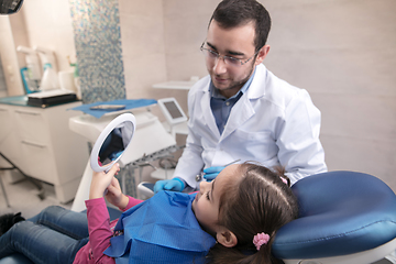 Image showing Young caucasian girl visiting dentist\'s office