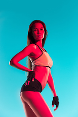 Image showing Muscular young female athlete on blue background