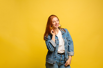 Image showing Caucasian woman\'s portrait isolated on yellow studio background