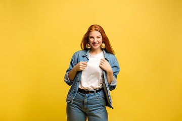 Image showing Caucasian woman\'s portrait isolated on yellow studio background