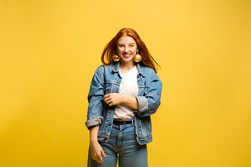 Image showing Caucasian woman\'s portrait isolated on yellow studio background