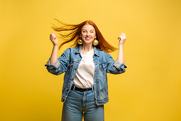 Image showing Caucasian woman\'s portrait isolated on yellow studio background