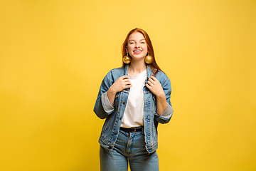 Image showing Caucasian woman\'s portrait isolated on yellow studio background