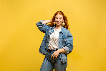 Image showing Caucasian woman\'s portrait isolated on yellow studio background