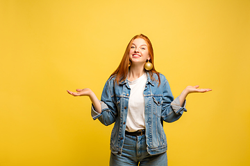 Image showing Caucasian woman\'s portrait isolated on yellow studio background