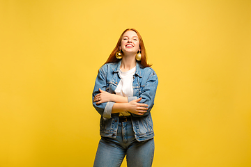 Image showing Caucasian woman\'s portrait isolated on yellow studio background