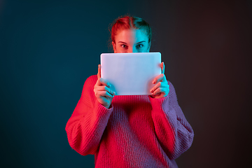 Image showing Caucasian woman\'s portrait isolated on gradient studio background in neon light