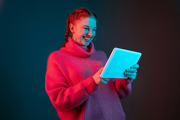 Image showing Caucasian woman\'s portrait isolated on gradient studio background in neon light