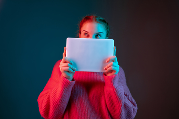 Image showing Caucasian woman\'s portrait isolated on gradient studio background in neon light