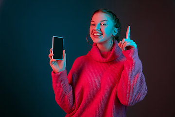 Image showing Caucasian woman\'s portrait isolated on gradient studio background in neon light