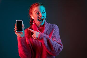 Image showing Caucasian woman\'s portrait isolated on gradient studio background in neon light