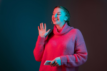 Image showing Caucasian woman\'s portrait isolated on gradient studio background in neon light