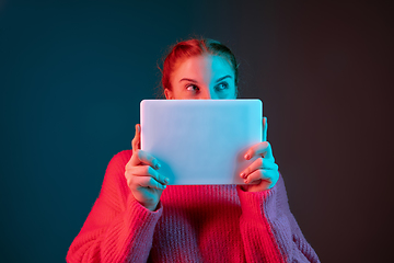 Image showing Caucasian woman\'s portrait isolated on gradient studio background in neon light