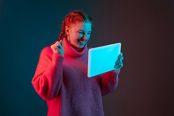 Image showing Caucasian woman\'s portrait isolated on gradient studio background in neon light