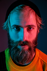 Image showing Caucasian man\'s portrait isolated on gradient studio background in neon light