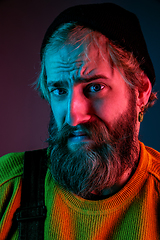 Image showing Caucasian man\'s portrait isolated on gradient studio background in neon light