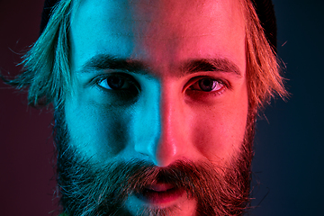 Image showing Caucasian man\'s portrait isolated on gradient studio background in neon light