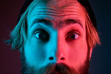 Image showing Caucasian man\'s portrait isolated on gradient studio background in neon light
