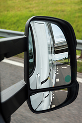 Image showing Road view from the side mirror. Traveling by car