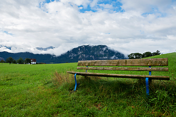 Image showing A calm place to rest and relax. An empty wooden bench. Switzerland