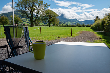 Image showing Camping table and chairs in the Switzerland Alps. Great view. Outdoor camping concept