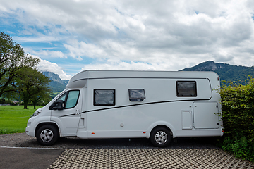 Image showing Caravan car vacation. Family vacation travel RV. Holiday trip in motorhome. Switzerland natural landscape