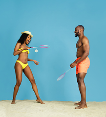 Image showing Happy young couple resting on blue studio background