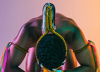 Image showing Muay thai. Young man exercising thai boxing on gradient background