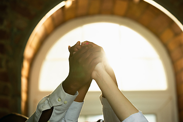 Image showing Close up of african-american and caucasian human\'s hands gesturing