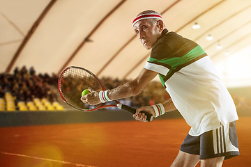 Image showing Senior man playing tennis in sportwear on stadium