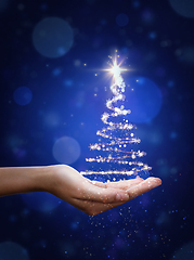 Image showing Blue Christmas tree in hand