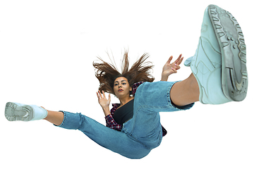 Image showing A second before falling - young girl falling down with bright emotions and expression