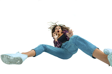 Image showing A second before falling - young girl falling down with bright emotions and expression