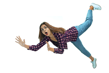 Image showing A second before falling - young girl falling down with bright emotions and expression