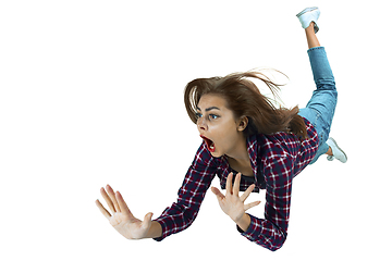 Image showing A second before falling - young girl falling down with bright emotions and expression