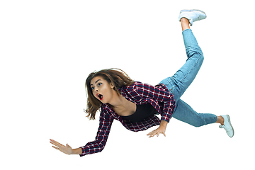 Image showing A second before falling - young girl falling down with bright emotions and expression